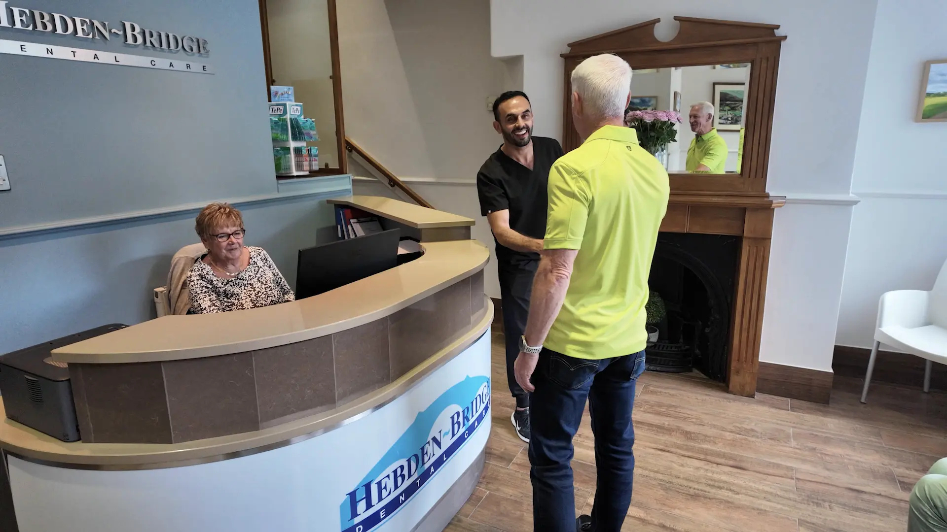 Dr. Nadeem Sabir discussing dental implant fees with patient