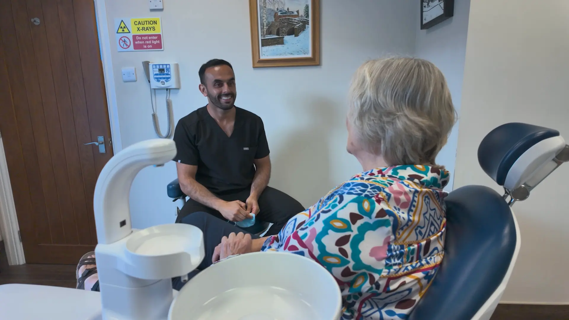 Dr. Nadeem Sabir with patient in dentists chair