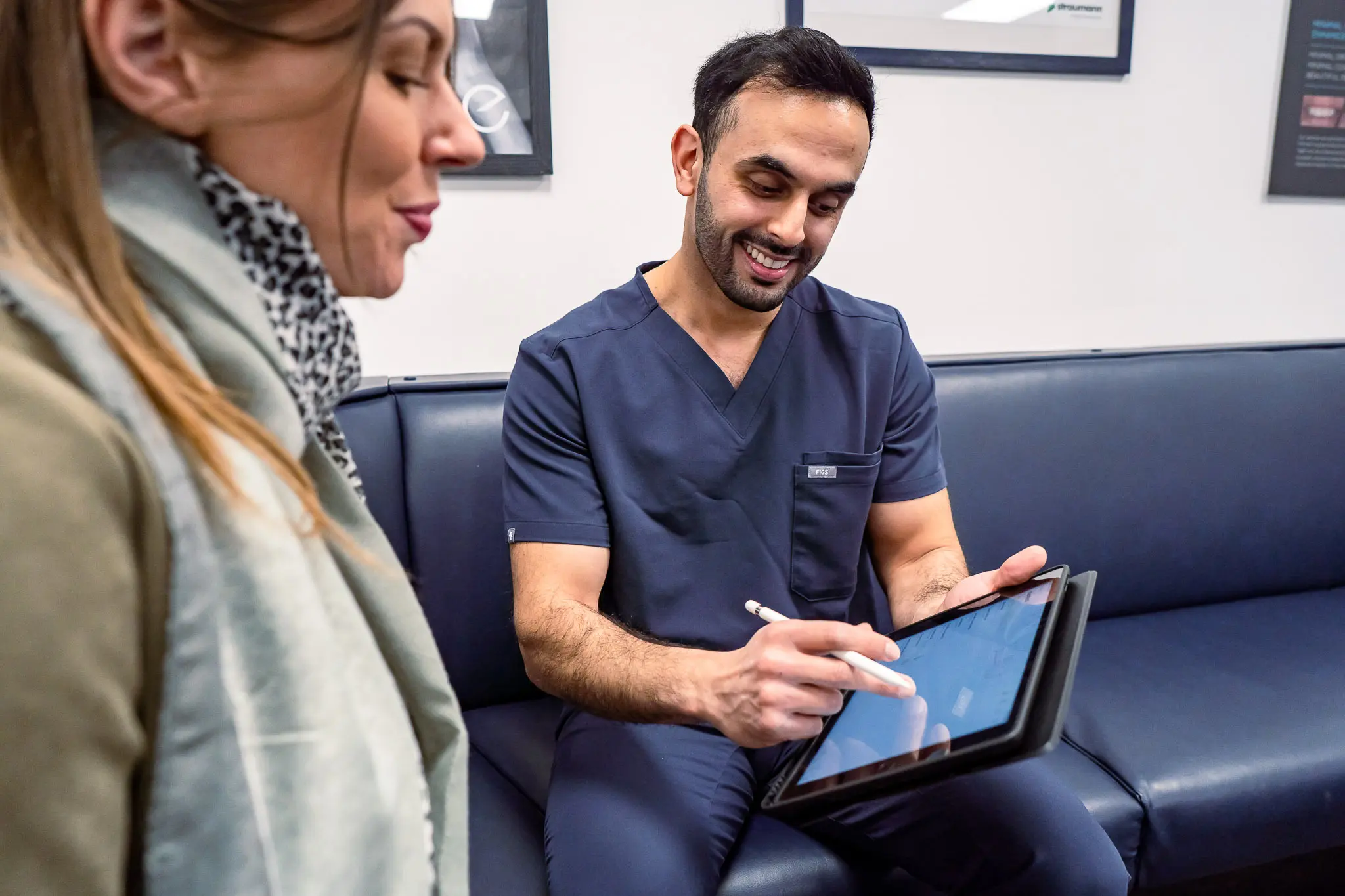 Dr. Nadeem Sabir discussing dental implant fees with patient